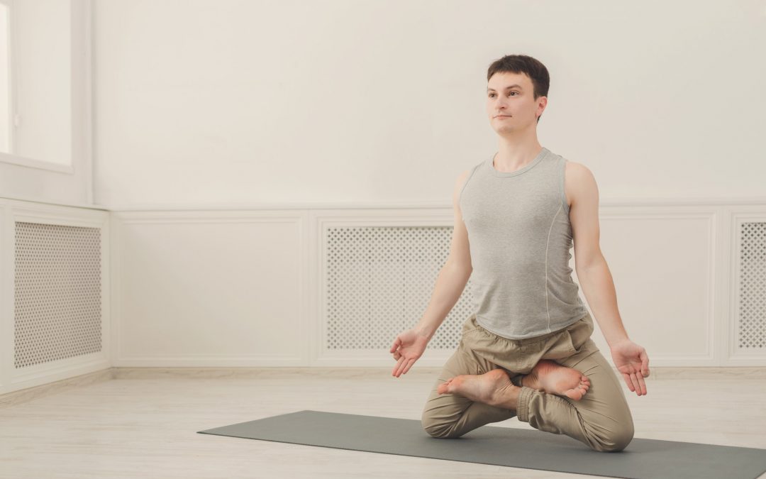 Sporty man practicing yoga. Lotus pose.